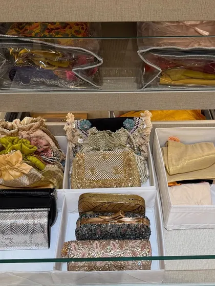 A drawer dedicated to festive and evening clutches. Using dividers and bins prevents these delicate items from getting damaged and makes them easy to find before a special event.