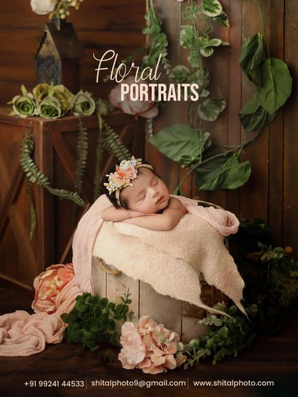 A beautiful example of our floral portraits, with the baby sleeping in a bucket surrounded by lush greenery and soft pink flowers for an enchanted garden feel.