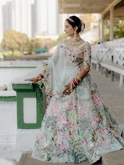 The full view of Bhoomi's stunning floral lehenga. The soft, minimal makeup ensures that the focus remains on the intricate details of her outfit and her natural beauty.