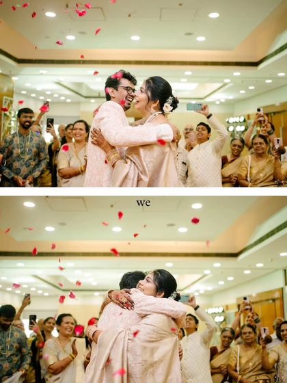 A moment of pure celebration as the couple hugs after their intimate 'Two-States' wedding ceremony, showered with rose petals by their loved ones.
