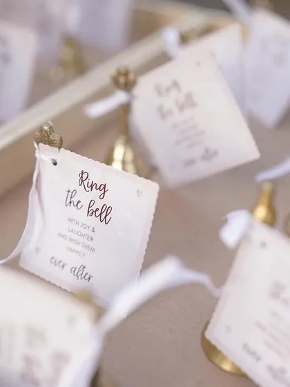"Ring the bell for them to kiss!" A tray of small bells for guests, a fun and interactive way to celebrate the couple's happy moments.