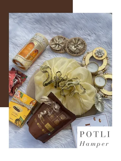 This is my classic potli hamper, a celebration of tradition and charm. It’s filled with brownie chips, dhoop sticks, and decorative tea lights, all bundled in a beautiful organza potli.