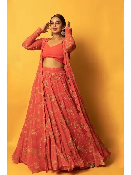 A full-length view of the orange Paulmi and Harsh lehenga, showing how the coordinated set creates a striking and stylish silhouette.