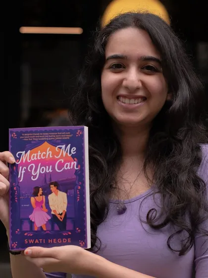Holding up my first book baby, *Match Me If You Can*. It's a friends-to-lovers story set in Mumbai, and it's available now.