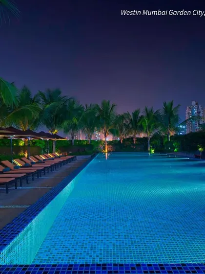 The poolside at Westin Mumbai Garden City at night. The beautiful lighting creates a glamorous and sophisticated atmosphere for an evening event.