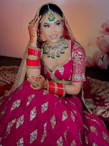 A smiling bride, happy with her final look. The makeup enhances her features and gives her a radiant glow.