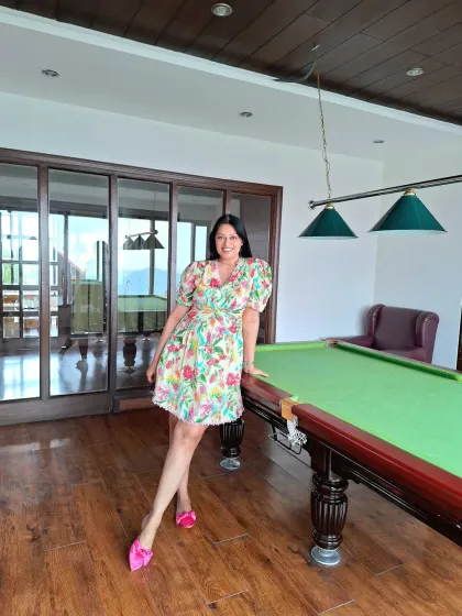 The same floral dress styled indoors. Its versatility makes it a great addition to any travel wardrobe.