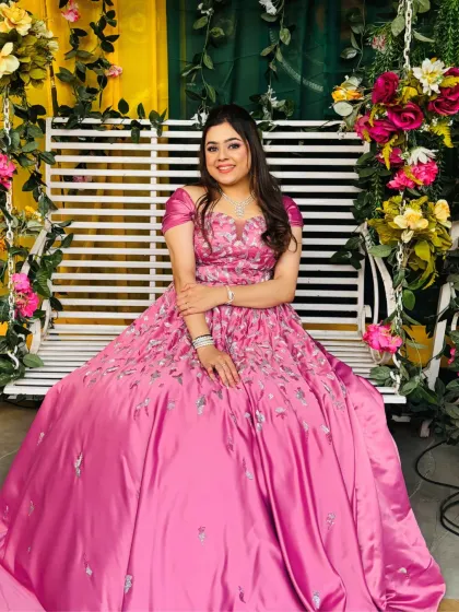 Posing by the floral decor, this bride-to-be looks absolutely stunning. Her makeup was kept clean and elegant to complement her beautiful pink gown.