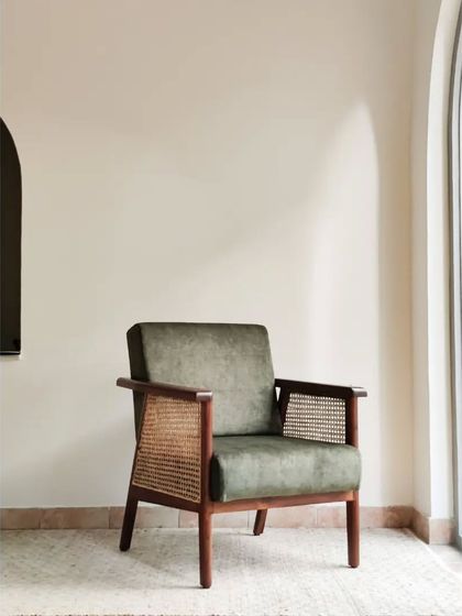 The Ballygunge chair is one of our most loved pieces. Crafted with a solid teak frame, natural rattan weave, and plush upholstery, it stands out as a statement lounge chair that offers exceptional comfort and style.