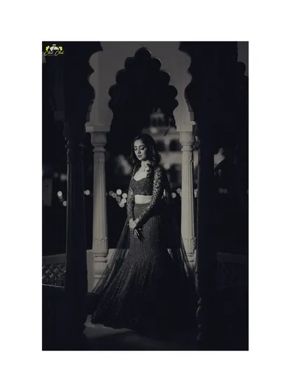 A dramatic black and white portrait of the bride, using light and shadow to create a timeless and artistic image before her sangeet.