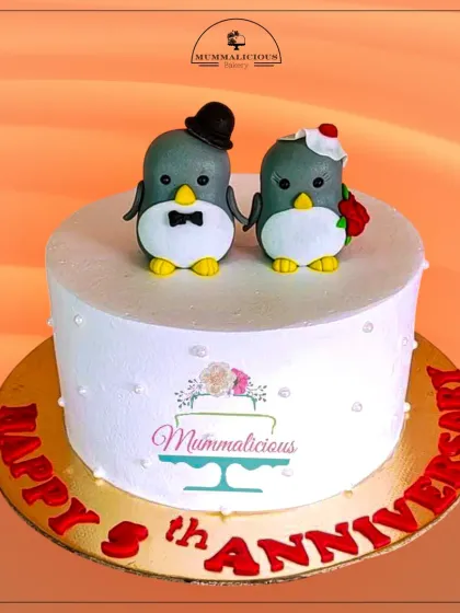 Happy Anniversary! This cute cake with two adorable penguin toppers is a whimsical and sweet way to celebrate your love. The simple, clean design puts the focus on the charming couple.