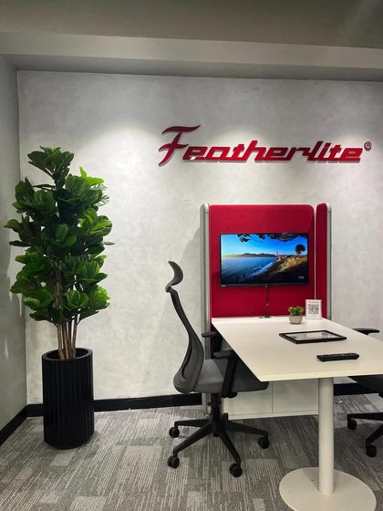An artificial Fiddle Leaf Fig tree adds a touch of nature to the Featherlite office space. It's a perfect, no-fuss solution for a professional environment.