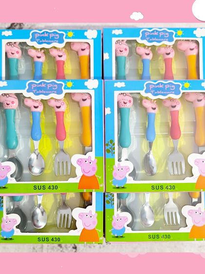 A close-up of the Peppa Pig cutlery set, which includes two spoons and two forks with character handles, made from child-safe stainless steel.
