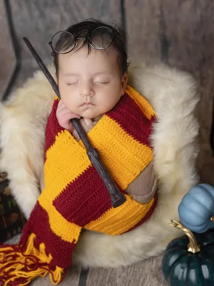 Sleeping soundly with his wand, this baby is dreaming of magic.