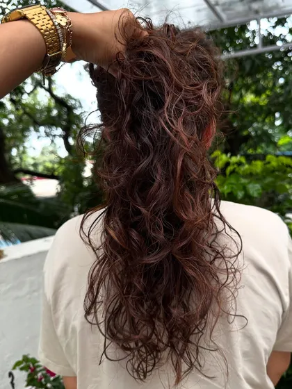 Curly and proud. I gave her curls a new life with a fresh cut, including a fringe, and subtle reddish-brown highlights to define the texture. Embracing your natural curls is always a good idea.