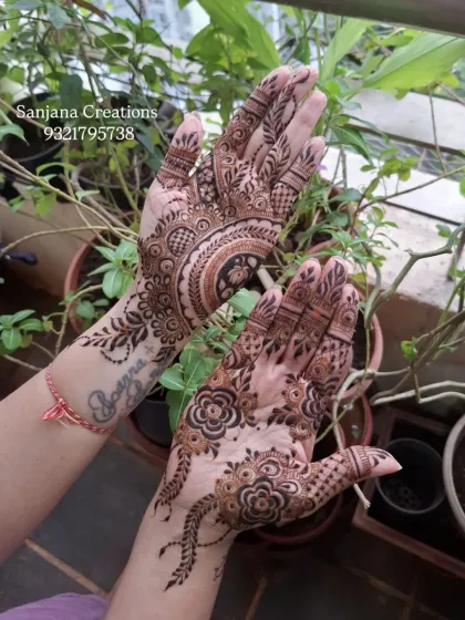 A unique design combining different styles, with one hand featuring a mandala and the other a flowing vine.