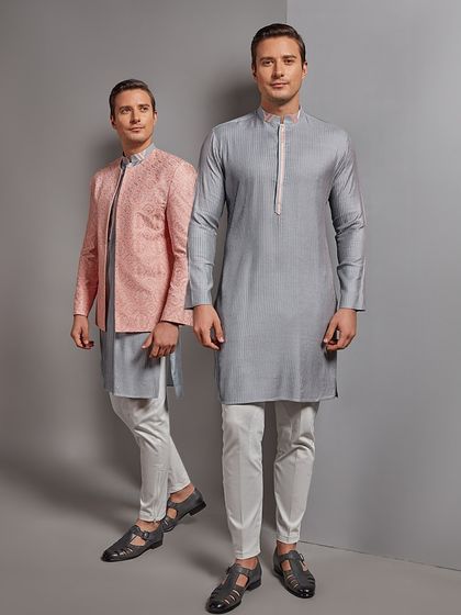 Turning every occasion into a statement of class. This image showcases two contemporary ethnic looks, one with a pink embroidered jacket and the other a sleek grey kurta.