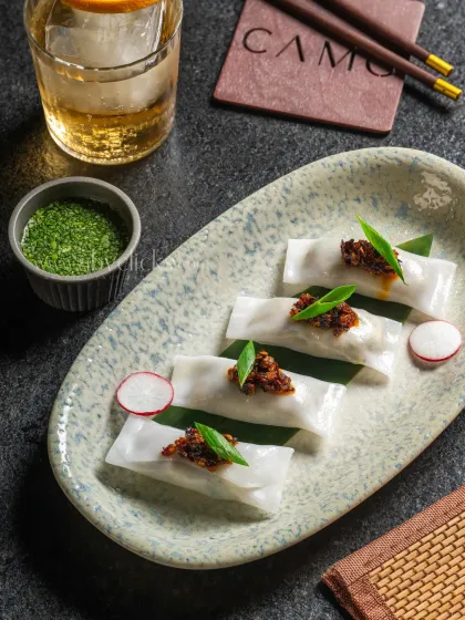 Cheung Fun or rice noodle rolls, elegantly plated with a drink for Camo, Noida.