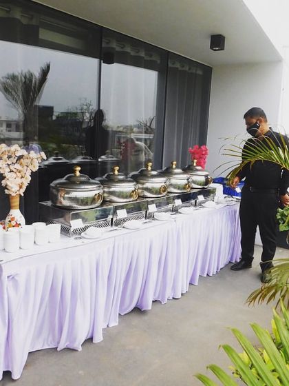 My staff setting up an outdoor buffet on a beautiful terrace. I can cater in any location, ensuring a professional setup regardless of the venue.