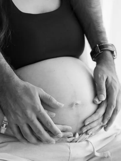 A close-up on the connection. Sometimes the most powerful stories are told in the smallest details, like the gentle touch of hands cradling a new life.