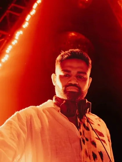 A dramatic, orange-lit selfie from the DJ booth. This captures the heat and intensity of a packed club night.