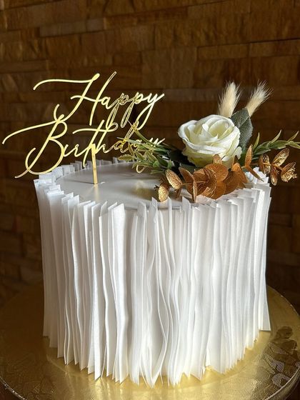 We love the elegant texture of wafer paper ruffles. This white and gold cake is a perfect example, creating a sophisticated look for a birthday or anniversary.