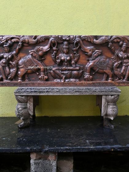 The full 48-inch Gaja Lakshmi panel, a classic and auspicious piece for any home, shown here resting on an antique-style bench.