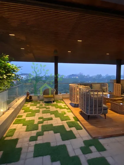 Another angle of the completed rooftop, showing the unique flooring that combines stone pavers with artificial grass squares. This highlights our attention to creative and practical design details.
