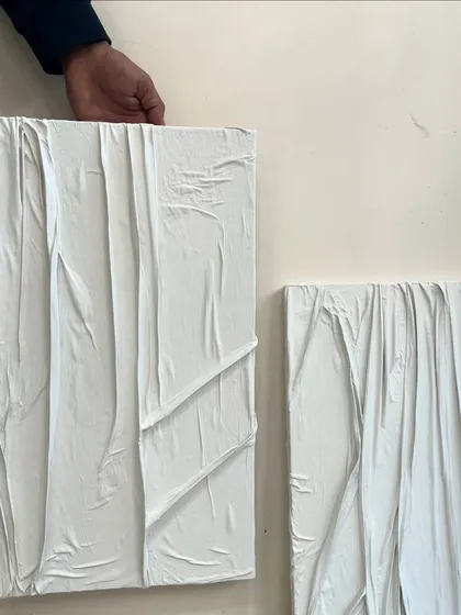 A hand holding one of the white fabric texture pieces to show its scale. Even smaller pieces can have a big impact when the texture is this detailed.