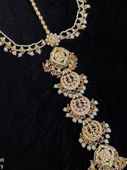 A 'Hair Choti' accessory or 'prandi' with intricate designs, perfect for decorating a bridal braid for a Punjabi or traditional look.