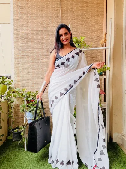 A quirky and fun white cotton Mulmul saree with a black spade print border. This is a great conversation starter and a unique addition to any saree collection.