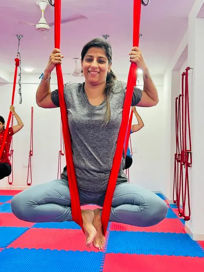 A simple seat in the hammock can be a powerful pose. This student finds her center and smiles, embodying the happy and supportive vibe of our studio.