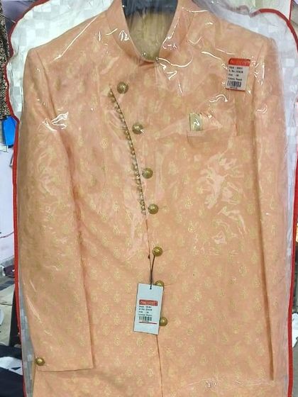 A brand new peach-colored Indo-western sherwani, still in its protective cover. I am constantly updating my collection with the latest designs and colors.