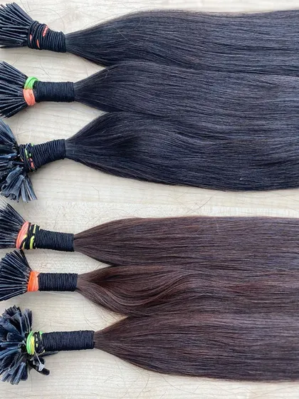 A collection of black and brown I-Tip extensions, demonstrating the natural color variations we offer.