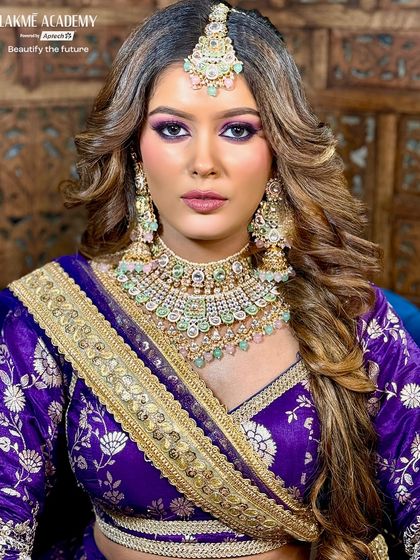 This vibrant reception look features a bold purple eyeshadow that complements the royal blue outfit. We teach advanced color theory so our students can confidently create stunning, coordinated looks for any event.