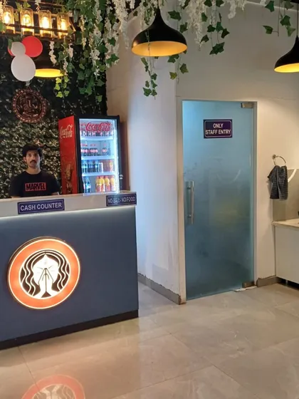 The front desk and entrance to the washroom area. I ensure every corner of my restaurant is clean and well-maintained.