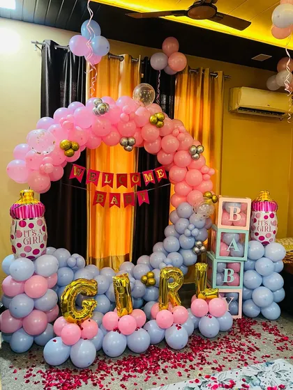 A closer look at a popular welcome home setup for a baby girl. The combination of the balloon arch, foil letters, and 'BABY' boxes creates a perfect photo corner.