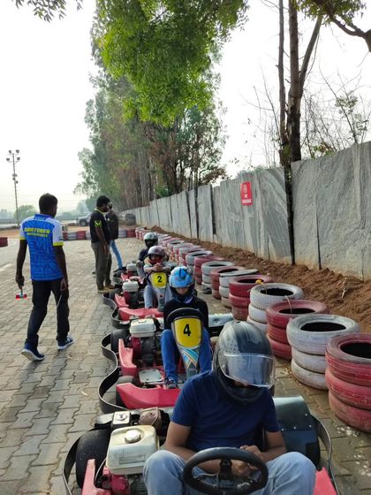 Lined up and ready to go. A group of aspiring racers prepares for their first coached session, learning about track etiquette and safety flags from the pit lane.
