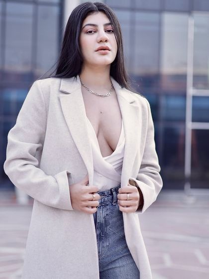 A confident, direct-to-camera look that combines street style with a touch of glamour.