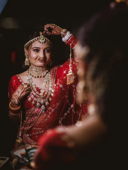 A beautiful shot of the bride looking at her reflection, a moment of quiet confidence before she walks down the aisle.