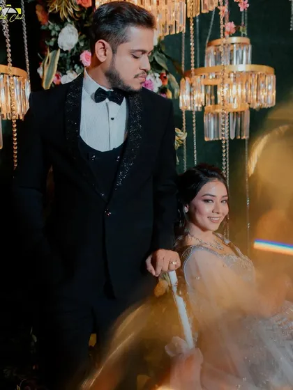 A stylish portrait with an artistic light flare, capturing the couple's modern elegance.