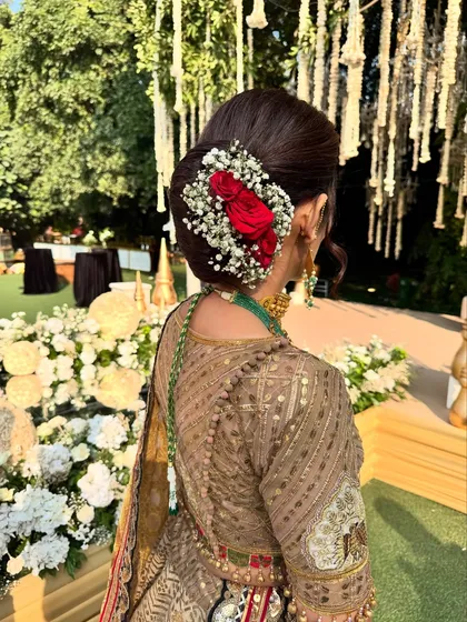 Another angle of this beautiful floral bun. It's the perfect hairstyle for a mother of the groom or bride, adding a touch of tradition and grace.