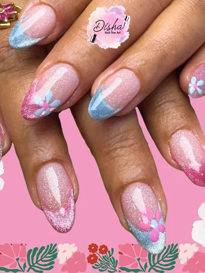A pretty combo of flowers and glitter. This design features a mix of pink and blue French tips with delicate, hand-painted floral accents.
