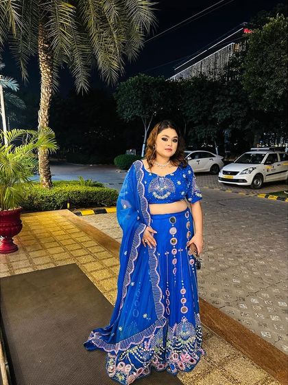 A client looking fabulous in a royal blue lehenga with unique mirror-work details. This is a fun and festive outfit, perfect for a sangeet or reception.