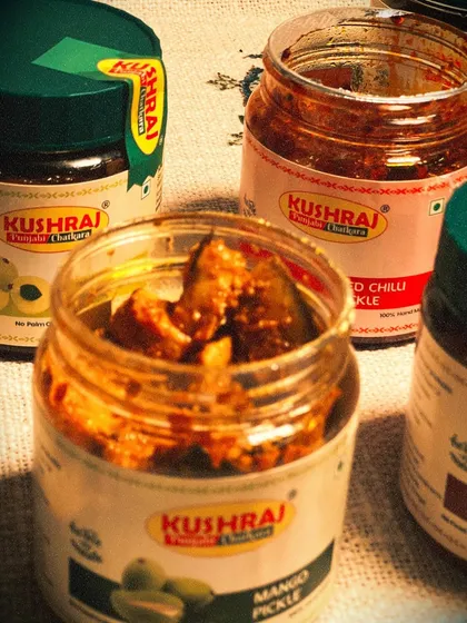 An open jar of my Mango Pickle, showing the generous chunks of mango soaked in flavourful oil and spices.