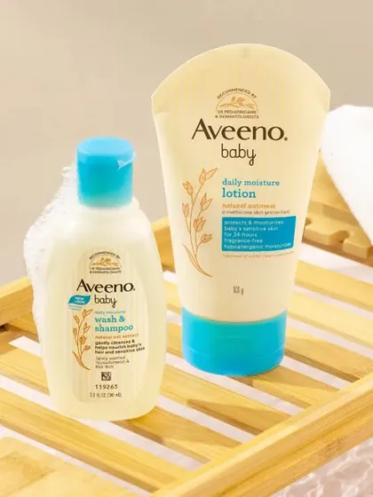A close-up lifestyle shot of baby care products on a bath caddy. We created a gentle, bubbly bath setting to communicate the product's mildness and suitability for a baby's bath time routine.