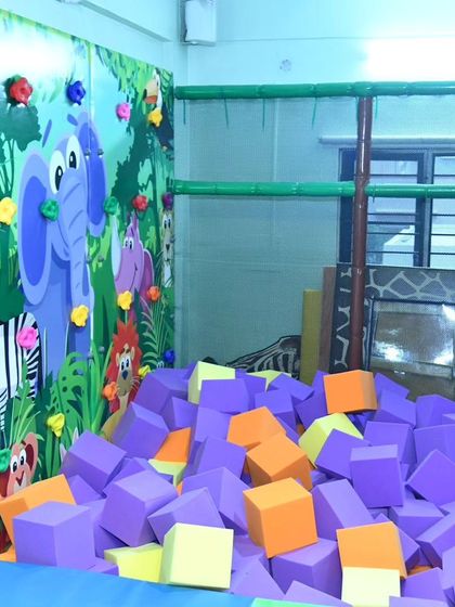 The foam block pit and climbing wall at our Banashankari center. The vibrant jungle-themed wall art adds to the immersive and playful atmosphere.