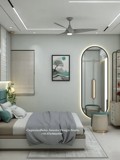 A view of the bedroom showing the large oval mirror and the window, which floods the room with natural light. The design is bright, airy, and elegant.