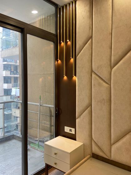 Another angle of the bedroom, showing the custom headboard next to the balcony door. This view emphasizes how we integrate natural light into our designs.
