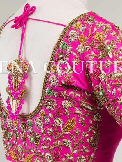 This bright pink raw silk blouse is a showcase of exquisite craftsmanship. The sleeves and back are covered in dense, multi-colored floral handwork, and I added beautiful custom tassels with bead detailing to complete the look.